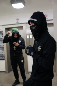 Best hoodie for winter streetwear look by THE 1010 BOYS featuring a black oversized hoodie outfit in an urban setting.