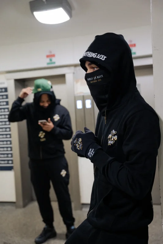 Best hoodie for winter streetwear look by THE 1010 BOYS featuring a black oversized hoodie outfit in an urban setting.