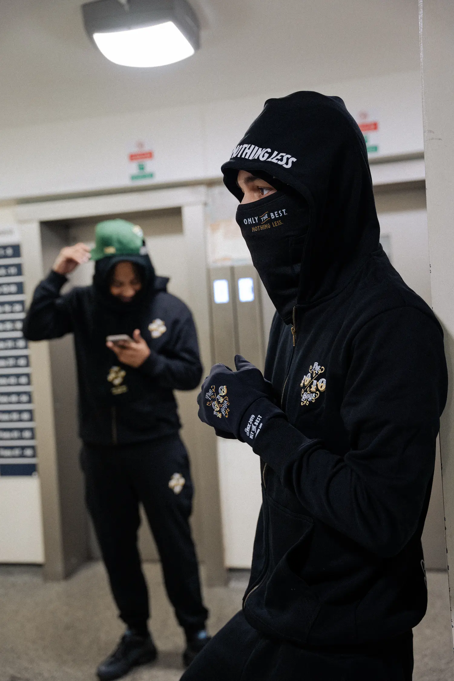 Best hoodie for winter streetwear look by THE 1010 BOYS featuring a black oversized hoodie outfit in an urban setting.