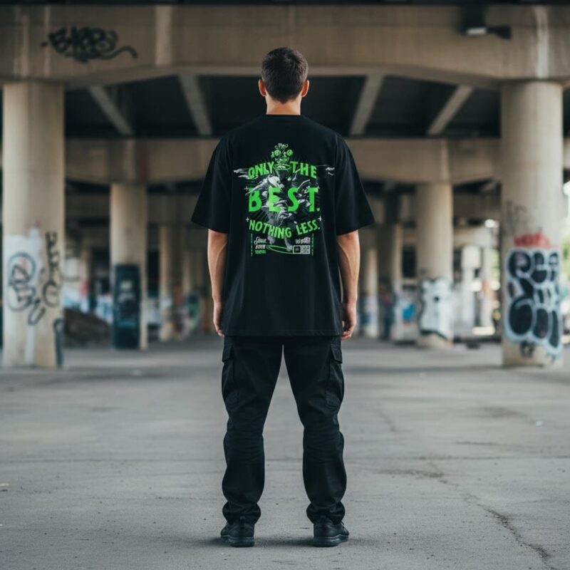 How to style oversized t-shirts: back view of a model wearing a black oversized streetwear T-shirt with neon green graphic print in an urban setting.