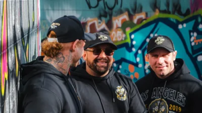 Man wearing a black streetwear cap with an oversized tee and relaxed trousers