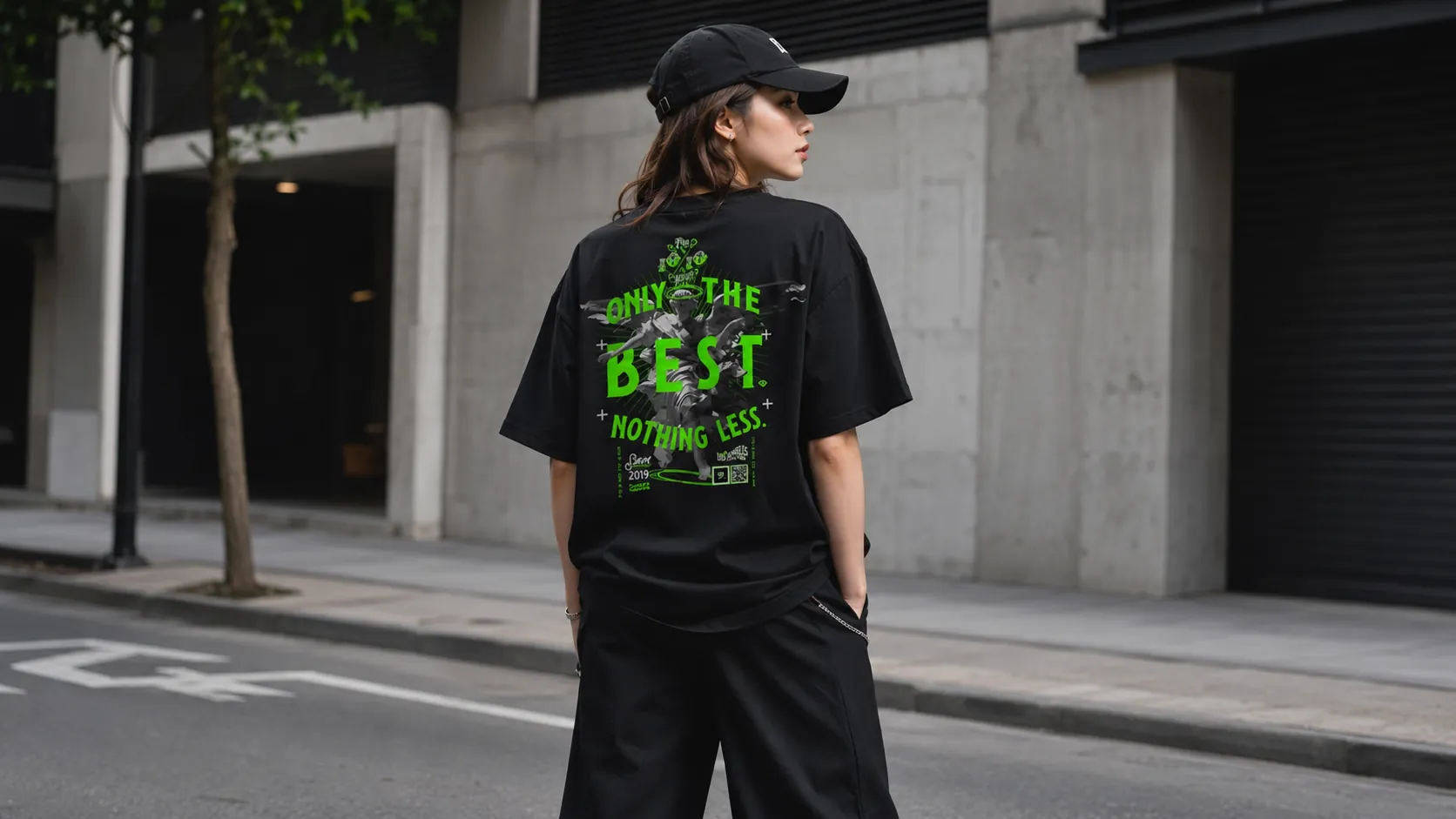 Everyday clean streetwear look styled with a black tee and cap in an urban setting