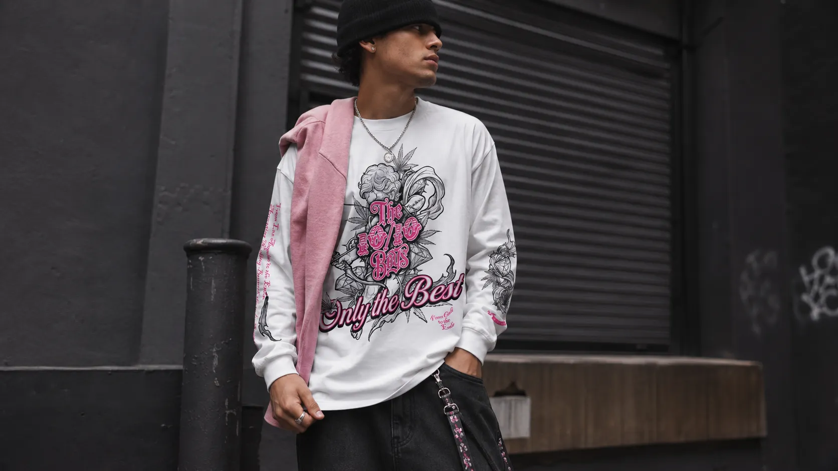 Close-up of the Pink Long Sleeve Shirt with white base, black graphics and pink details, styled for a clean streetwear look