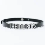 The 10/10 Boys chocker — black leather choker with polished THE 10/10 BOYS metal nameplate