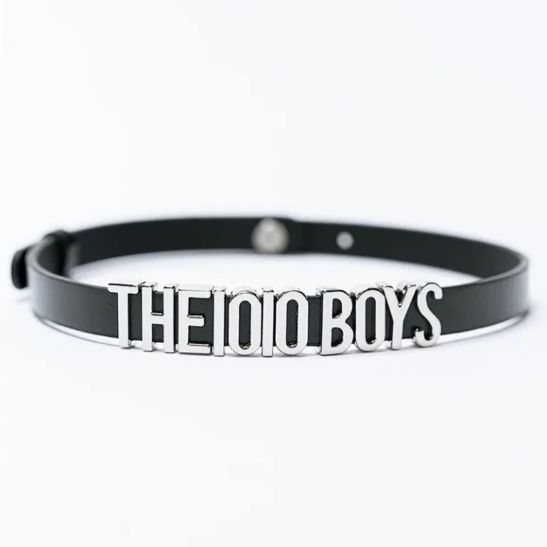 The 10/10 Boys chocker — black leather choker with polished THE 10/10 BOYS metal nameplate