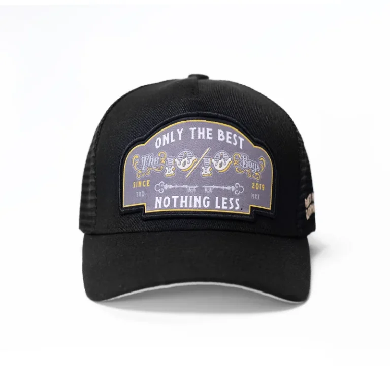 The 10/10 Boys Trucker Hat in black — front view with the "Only the Best, Nothing Less" badge patch