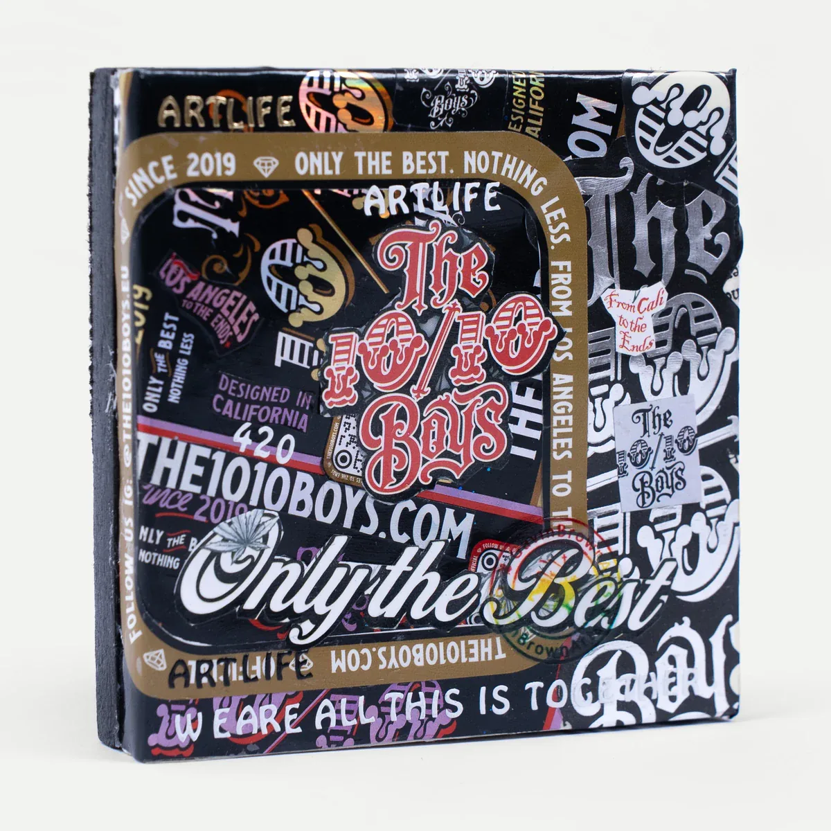 Stick It Art Mini Canvas No. 1 by GavinBrownArt: sticker-covered 10/10 Boys logo in a gold Stick It Art Mini Canvas No. 1 by GavinBrownArt: sticker-covered 10/10 Boys logo in a gold frame, front view