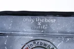Close-up of the Medium Laptop Bag: Only the Best × ArtLife over the GavinBrownArts seal on grey spray